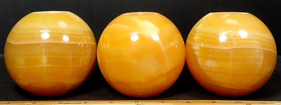 Orange Calcite Tea Light Candle Holder in the shape of a ball or sphere