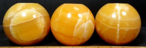 Orange Calcite Tea Light Candle Holder in the shape of a ball or sphere