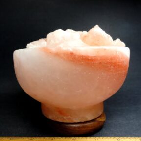 Salt lamp in the shape of a bowl with several small salt rocks resembling that of a water fountain