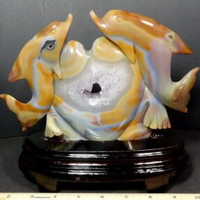 Dolphins caressing a heart carved from Agate with Amethyst center