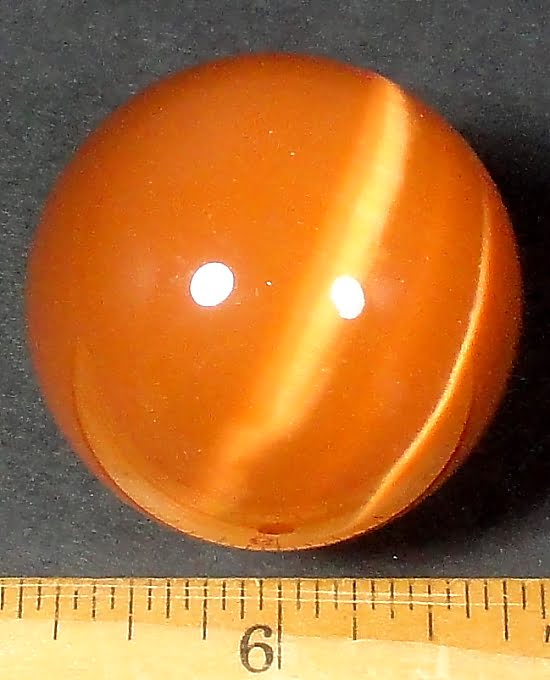 Orange Fiber Optic sphere measuring 50 mm in diameter and highly polished.