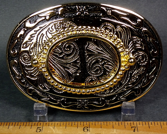 Gold plated belt buckle with a high shine and some black inlay